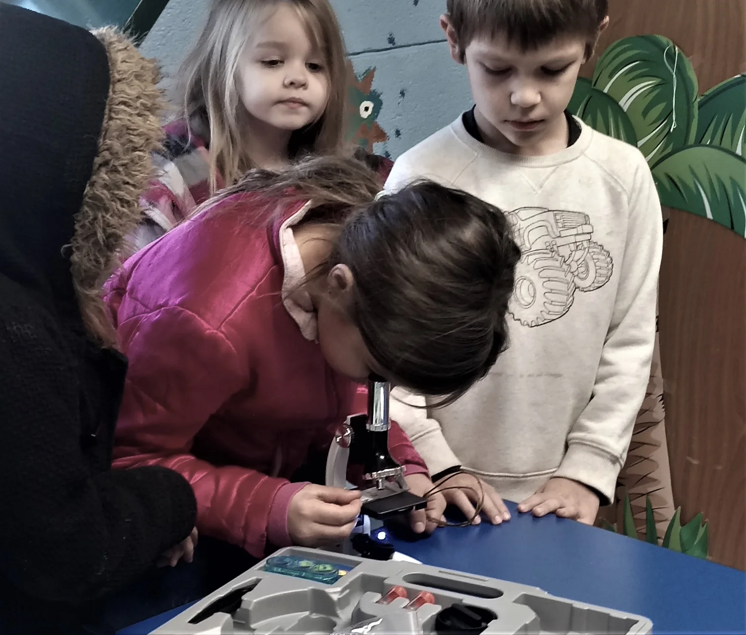 A young learner exploring with a microscope